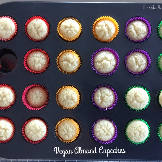Mini cupcake pan with Vegan Almond Cupcakes in paper wrappers