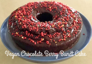 Photo of Vegan chocolate Berry Bundt cake on a blue cake stand